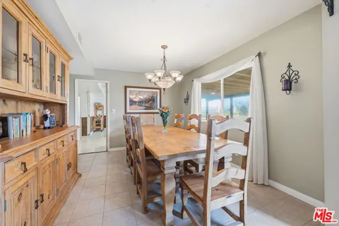 a view of a dining room with furniture and a chandelier