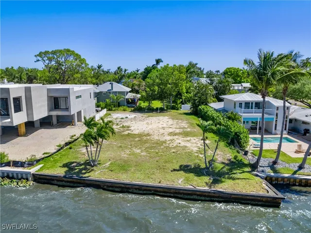 a view of a backyard with plants and a patio