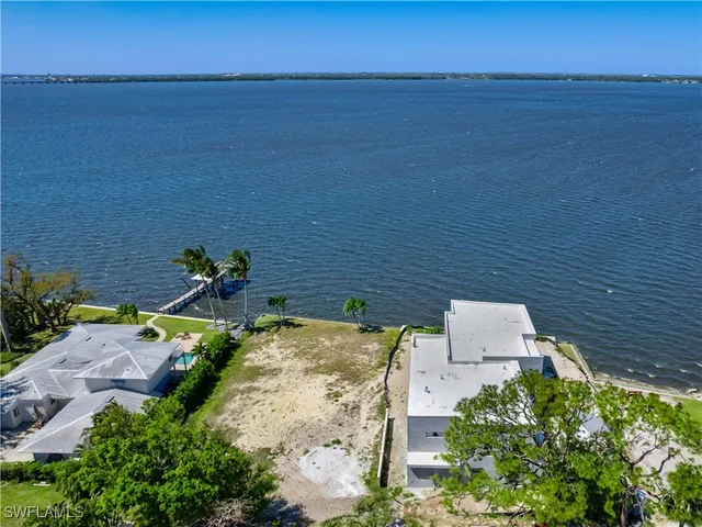 an aerial view of a house with ocean view