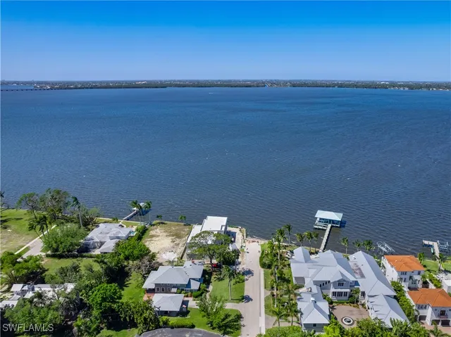 an aerial view of a house with lake view