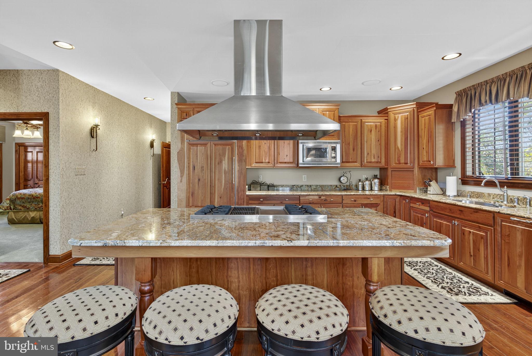 1631 Back Mountain Road Winchester, VA 22602 - Photo 15 of 86 a kitchen with stainless steel appliances granite countertop a stove a sink a dining table and chairs