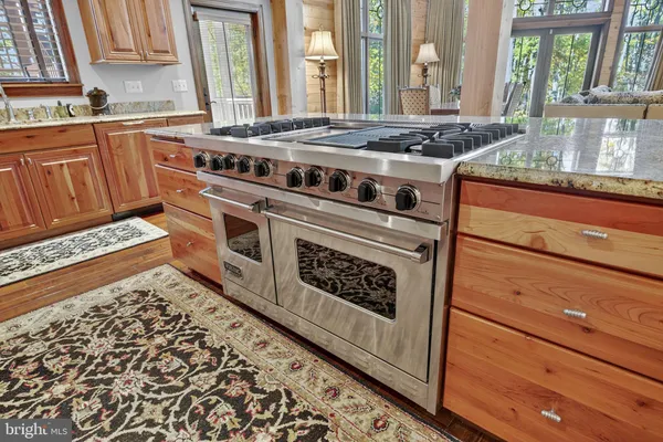 a bathroom with double vanity granite and a mirror
