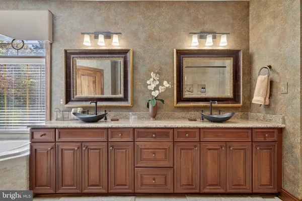a bathroom with a sink a mirror and a shower