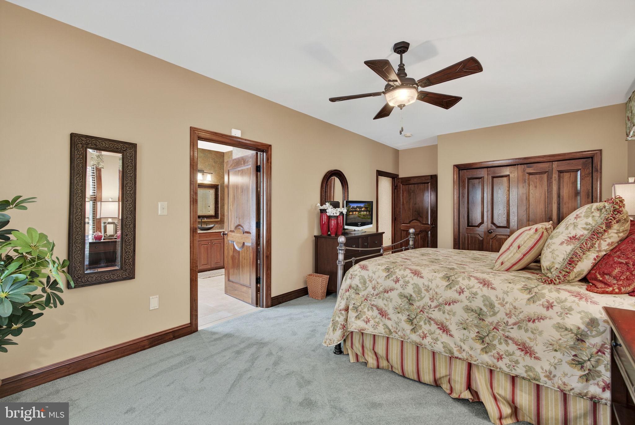 1631 Back Mountain Road Winchester, VA 22602 - Photo 31 of 86 a spacious bedroom with two large bed and a chandelier