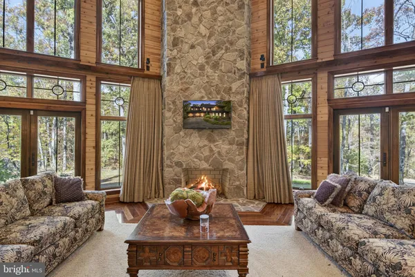 a kitchen with granite countertop a table chairs and wooden cabinets