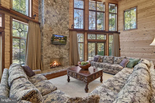 a kitchen with stainless steel appliances granite countertop a stove a sink a dining table and chairs