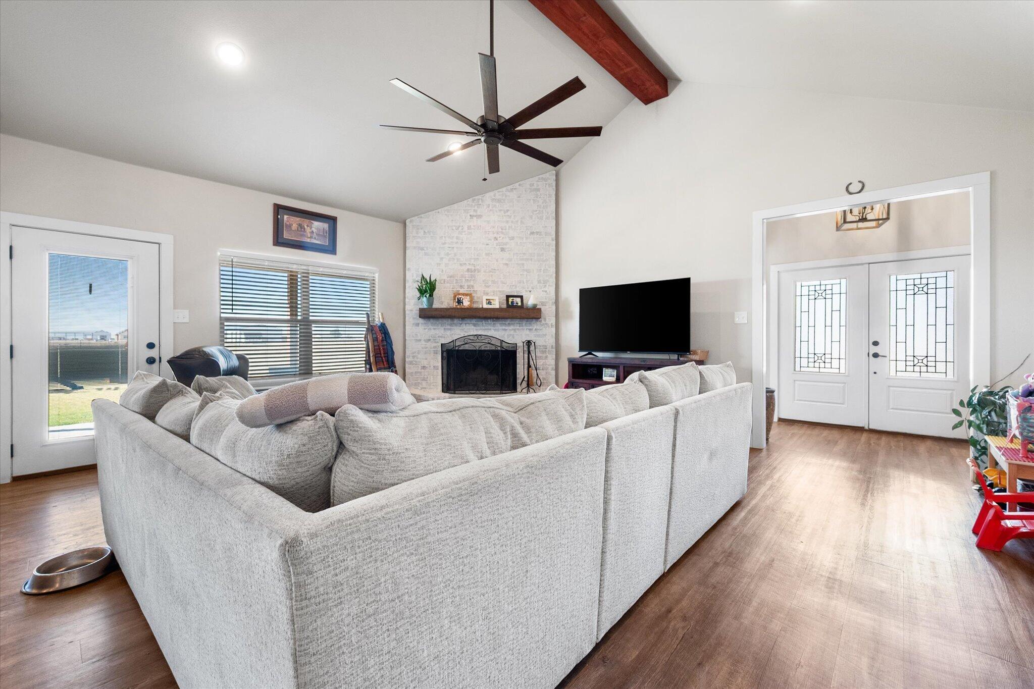 3263 Quail Road Lubbock, TX 79407 - Photo 12 of 46 a living room with furniture and a flat screen tv