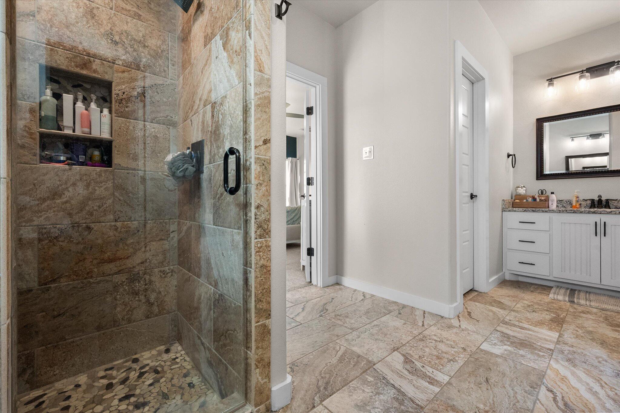 3263 Quail Road Lubbock, TX 79407 - Photo 19 of 46 a bathroom with a shower and a sink