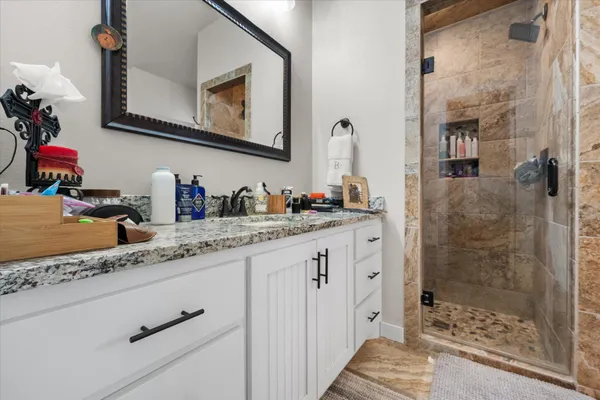 a bathroom with cabinets a sink and a mirror