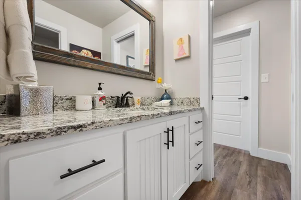 a kitchen with cabinets appliances and a wooden floor