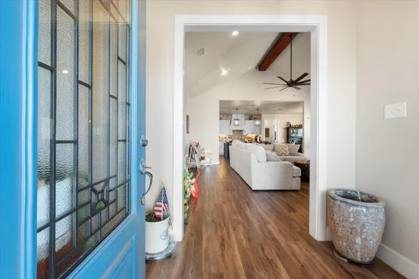 a living room with furniture and a wooden floor