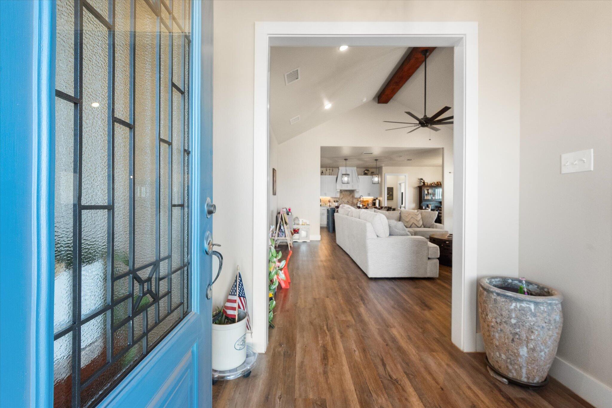 3263 Quail Road Lubbock, TX 79407 - Photo 3 of 46 a living room with furniture and a wooden floor
