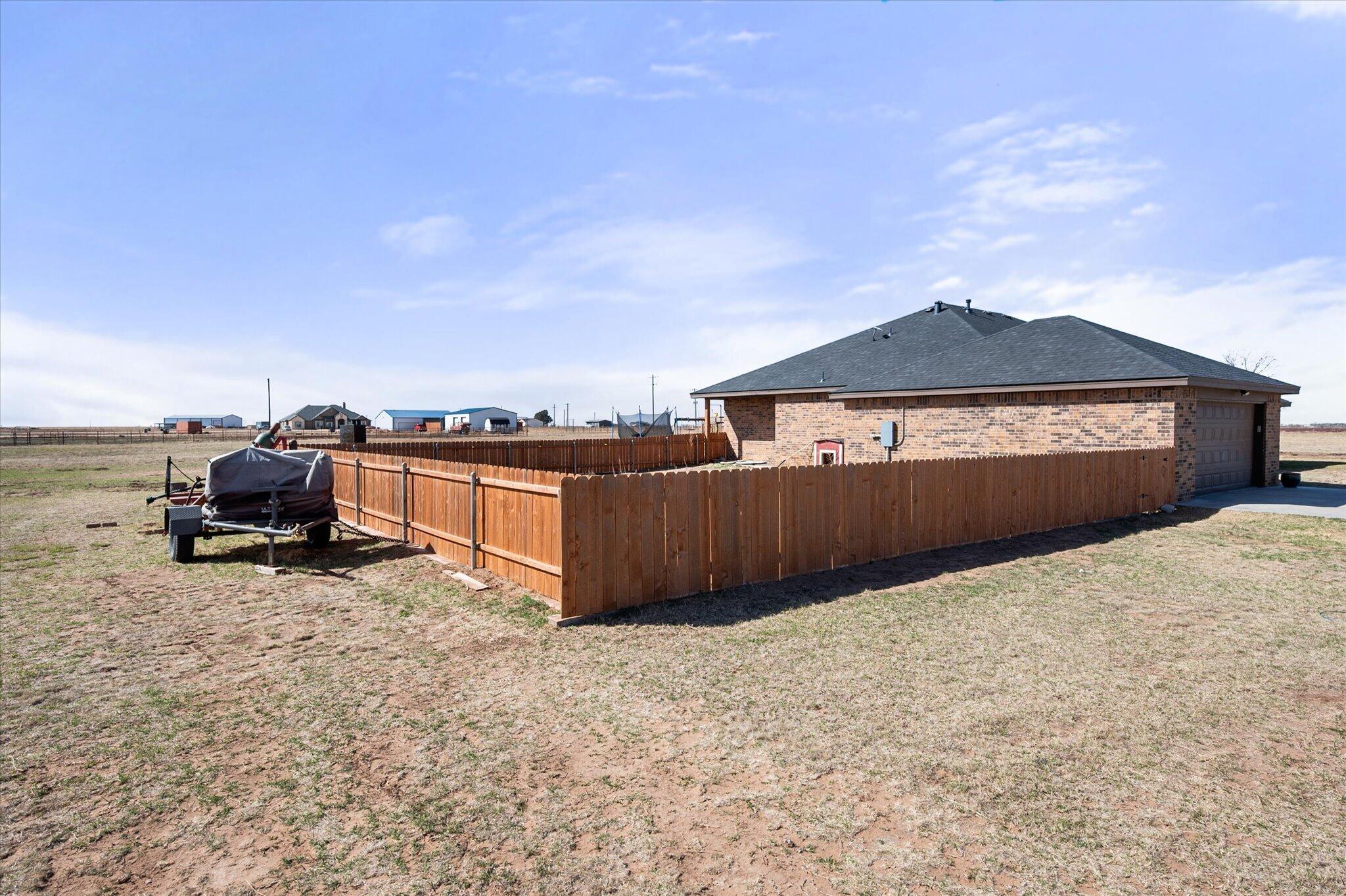 3263 Quail Road Lubbock, TX 79407 - Photo 33 of 46 a view of a house with a yard and sitting area