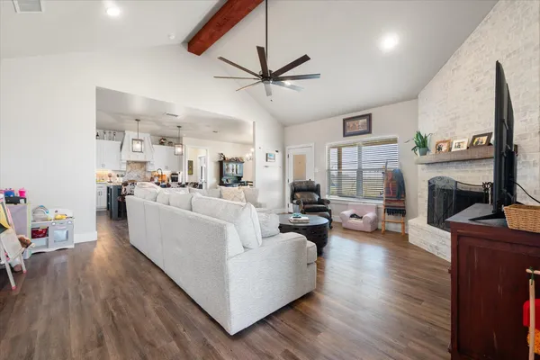 a living room with fireplace furniture and a wooden floor
