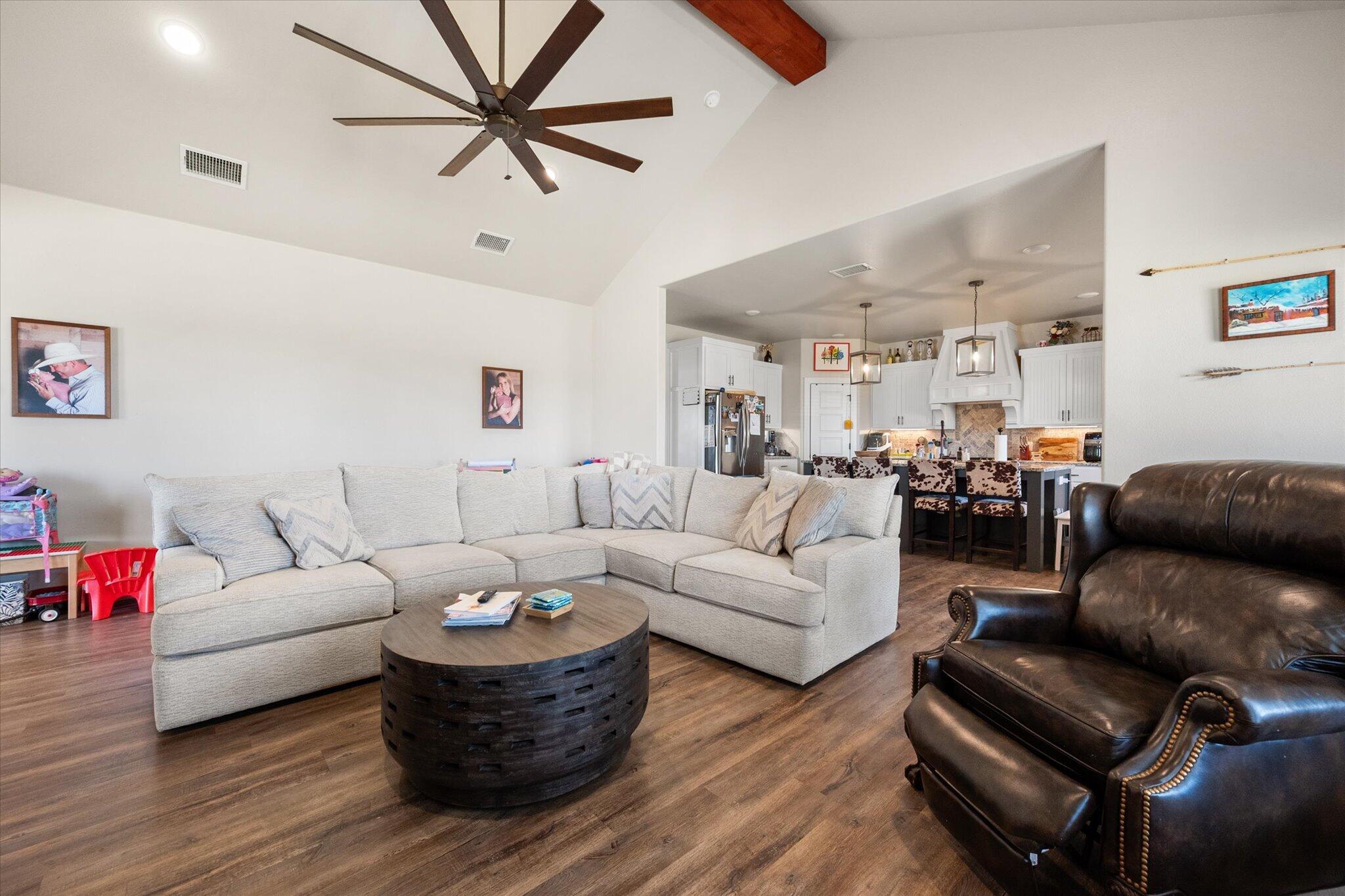 3263 Quail Road Lubbock, TX 79407 - Photo 6 of 46 a living room with furniture or couch and a wooden floor