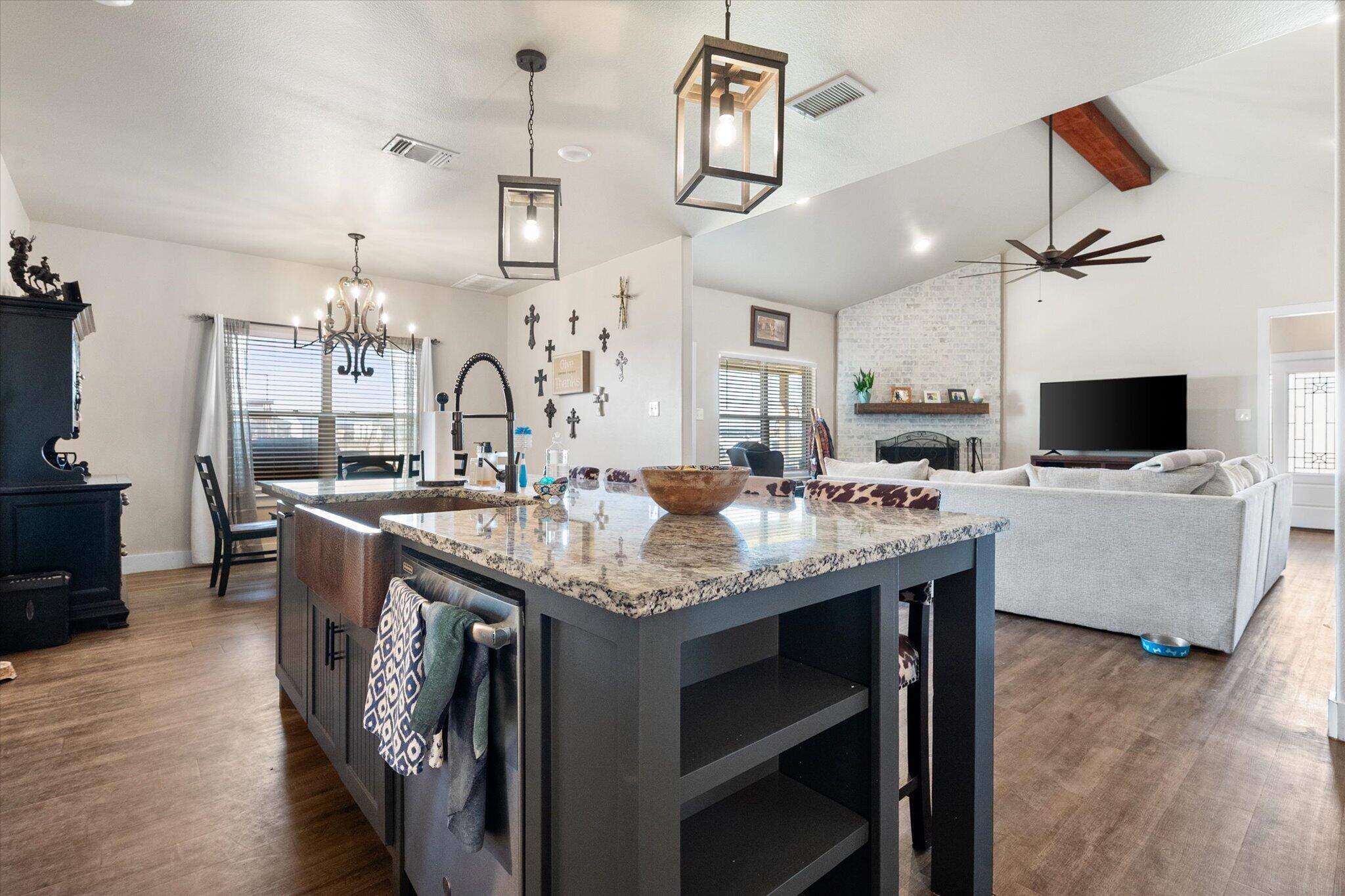 3263 Quail Road Lubbock, TX 79407 - Photo 9 of 46 a kitchen with a table chairs refrigerator and microwave