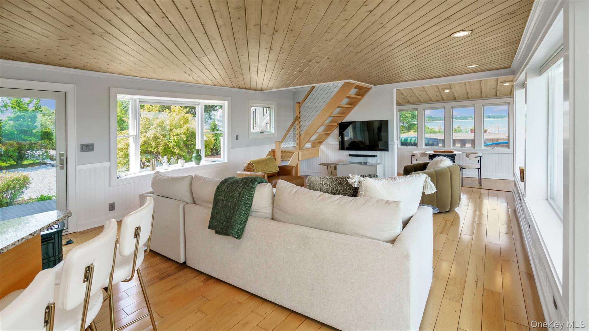 12910 Main Road East Marion, NY 11939 - Photo 12 of 41 a living room with furniture and a flat screen tv