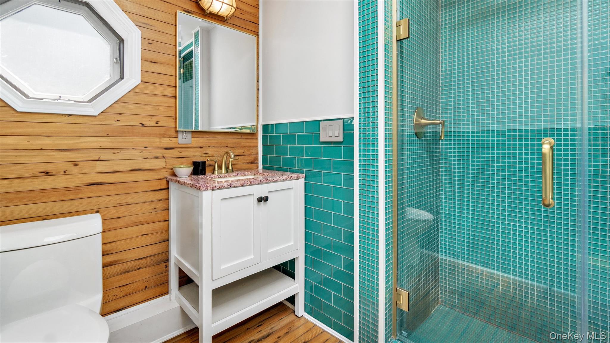 12910 Main Road East Marion, NY 11939 - Photo 17 of 41 a view of a bathroom with a sink and a mirror