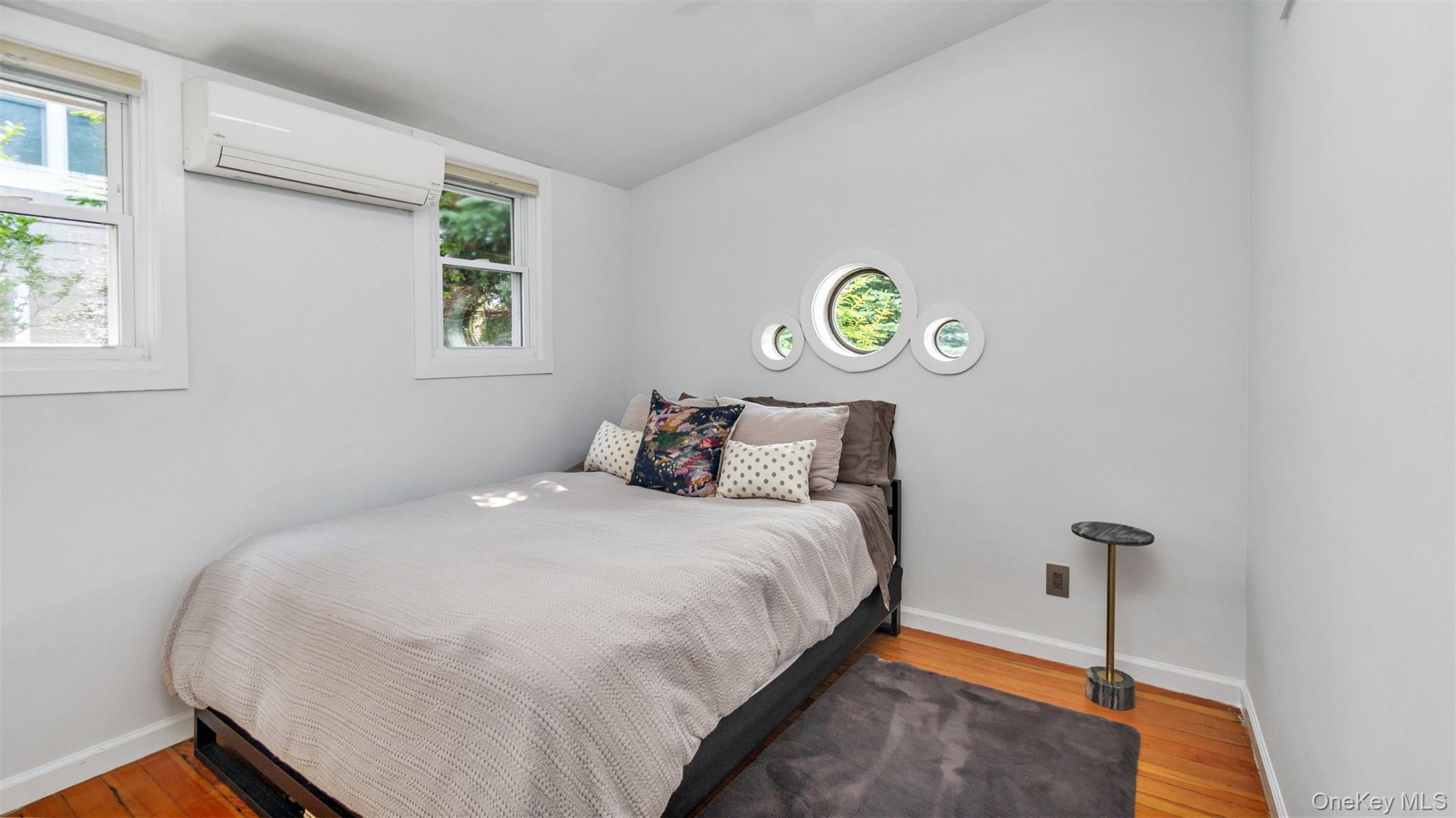 12910 Main Road East Marion, NY 11939 - Photo 21 of 41 a bedroom with a bed and a window