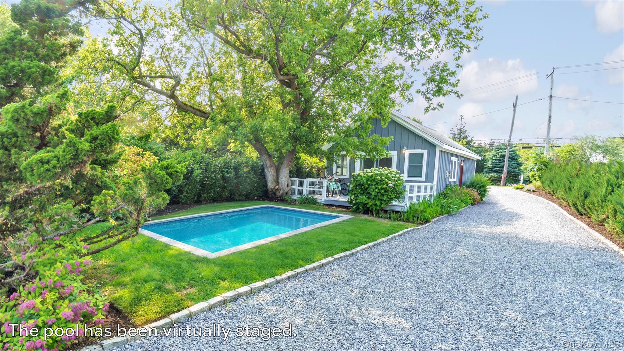 12910 Main Road East Marion, NY 11939 - Photo 24 of 41 a view of a backyard with plants and large trees