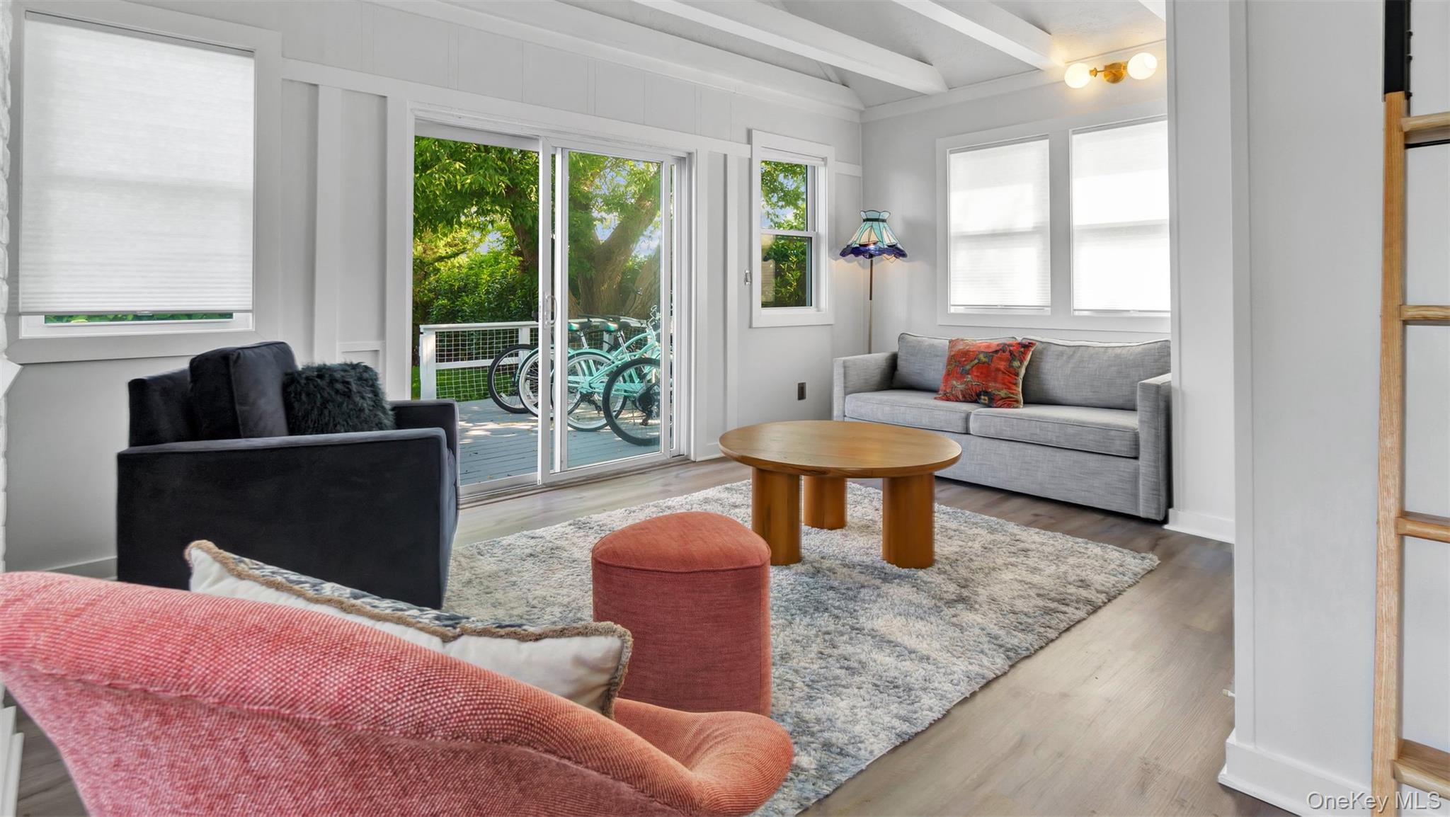 12910 Main Road East Marion, NY 11939 - Photo 28 of 41 a living room with furniture a window and a coffee table