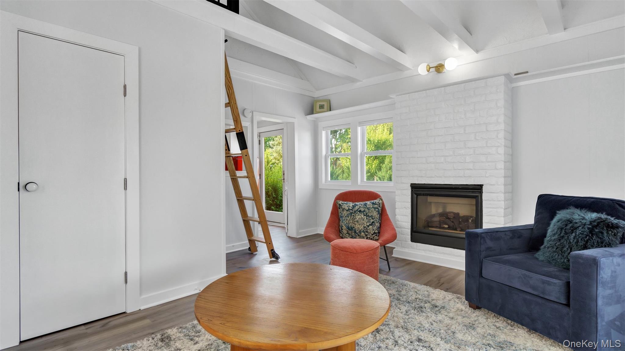12910 Main Road East Marion, NY 11939 - Photo 29 of 41 a living room with furniture and a fireplace