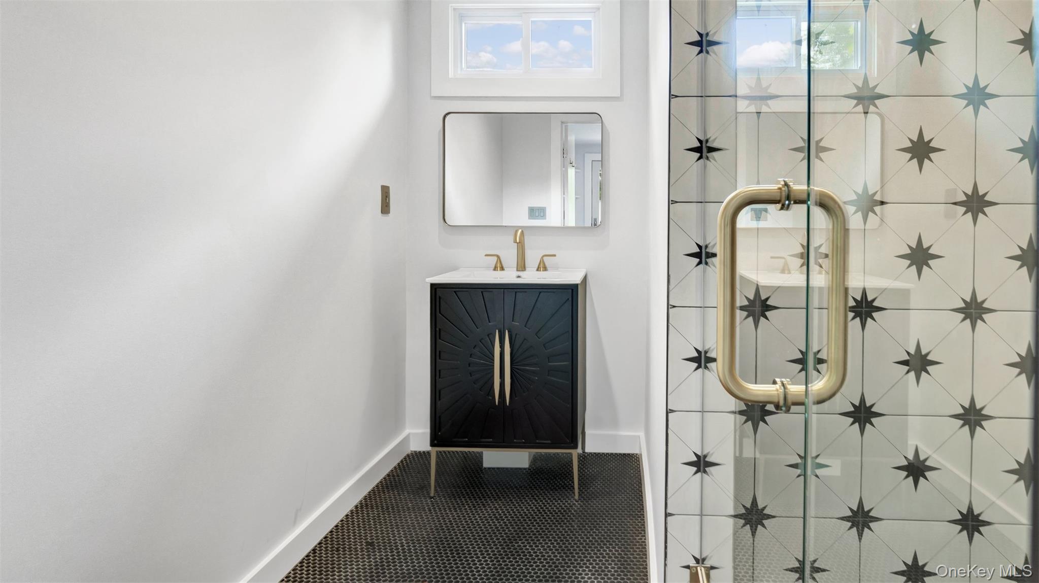 12910 Main Road East Marion, NY 11939 - Photo 33 of 41 a bathroom with a mirror and a shower