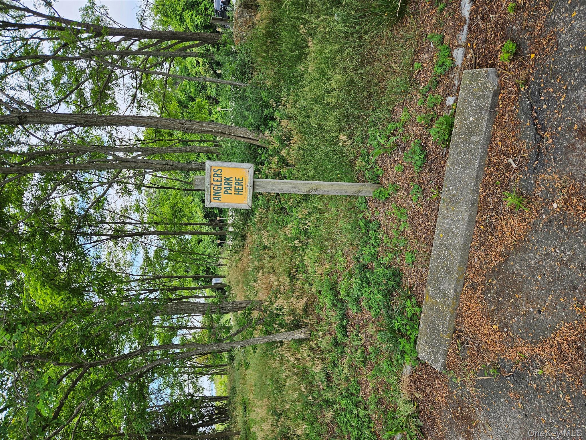 12910 Main Road East Marion, NY 11939 - Photo 40 of 41 a sign that is sitting in the middle of a yard