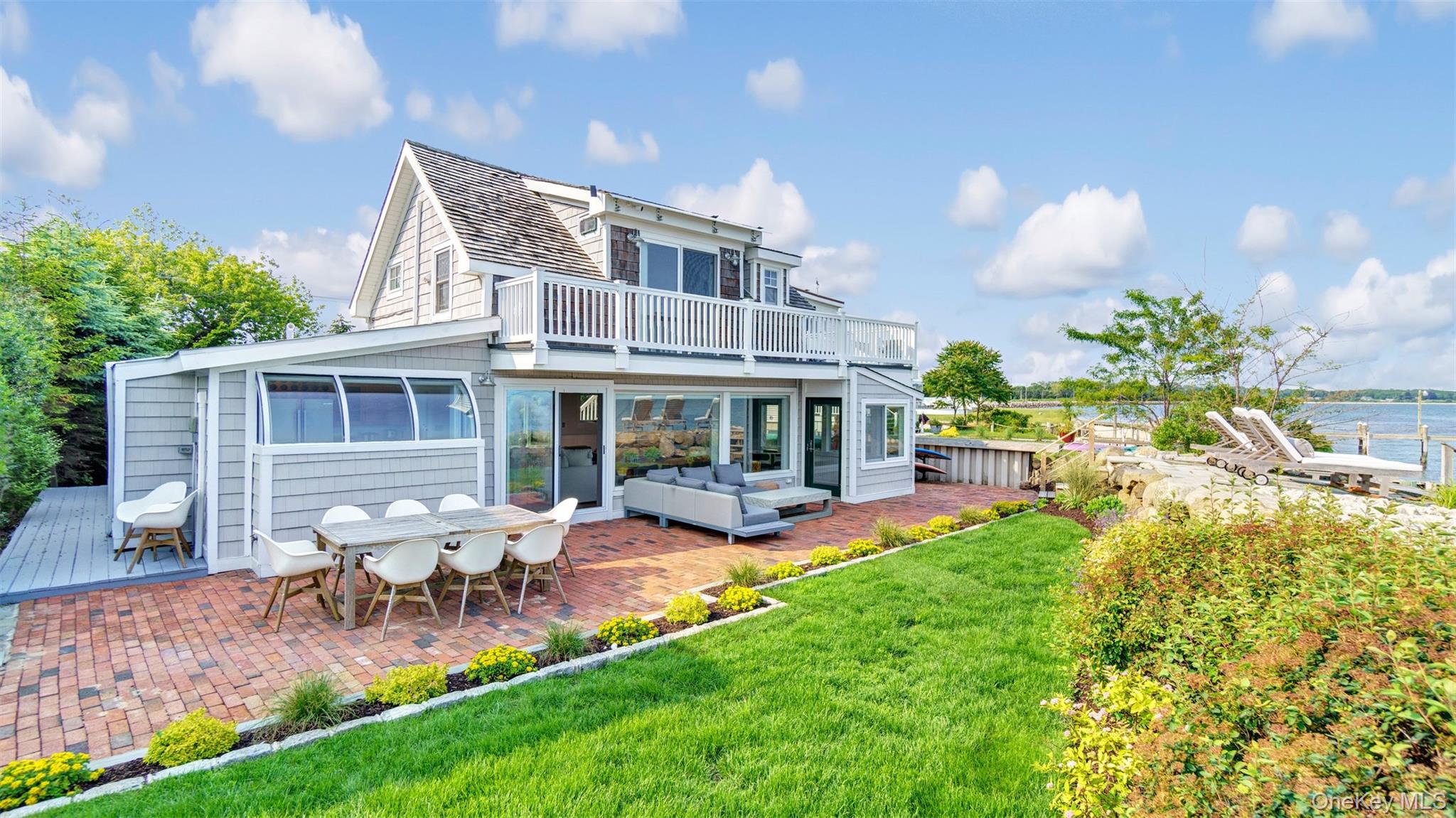 12910 Main Road East Marion, NY 11939 - Photo 5 of 41 a view of a house with a yard patio and fire pit