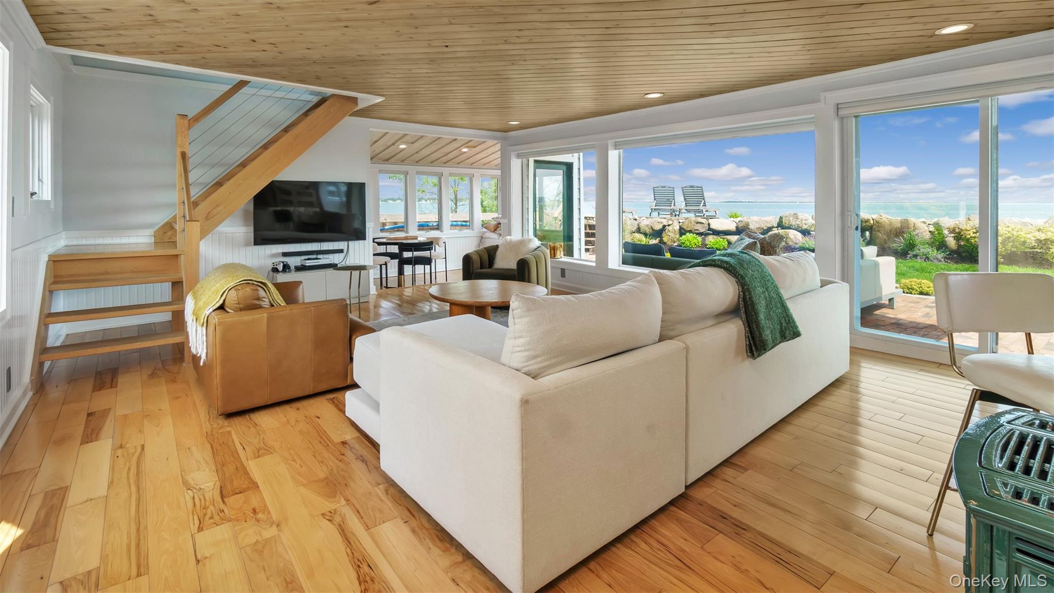 12910 Main Road East Marion, NY 11939 - Photo 10 of 41 a living room with furniture and a flat screen tv