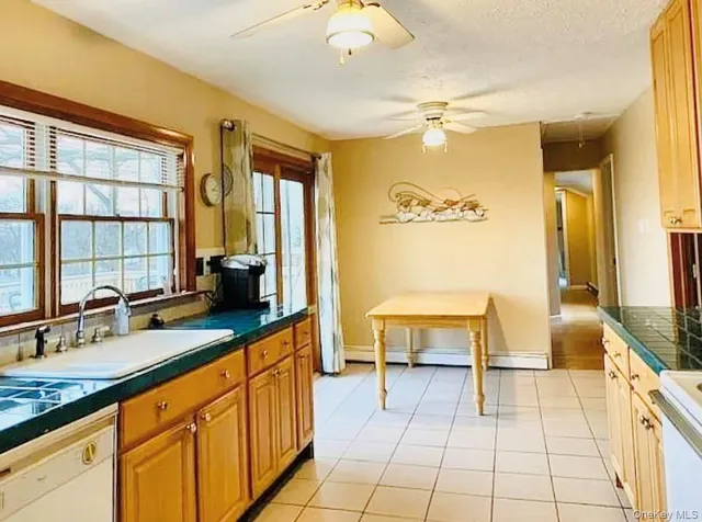 a spacious bathroom with a double vanity sink a mirror and a bathtub
