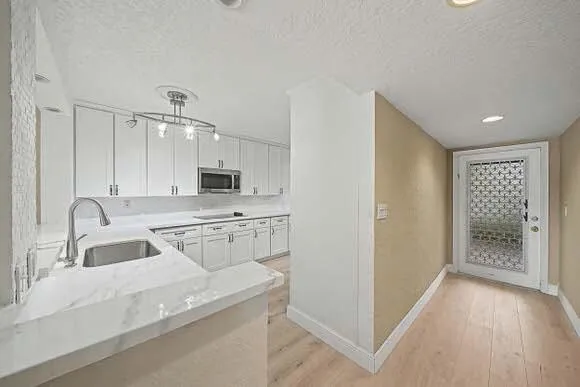 a bathroom with a granite countertop sink a toilet and a mirror