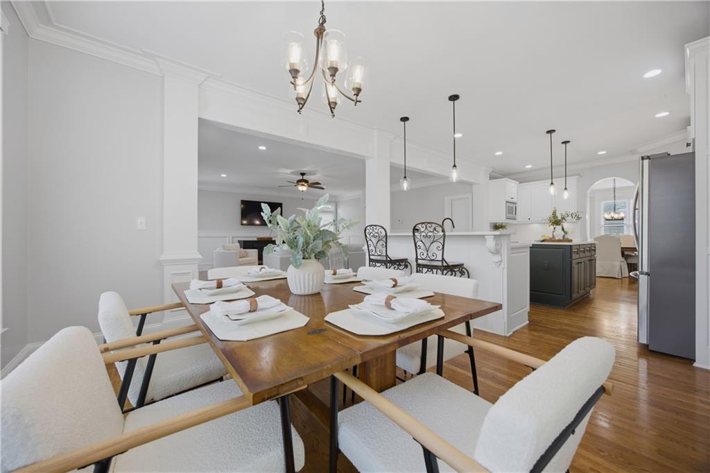 7988 Magnolia Square Atlanta, GA 30350 - Photo 11 of 33 a dining room with furniture a chandelier and wooden floor