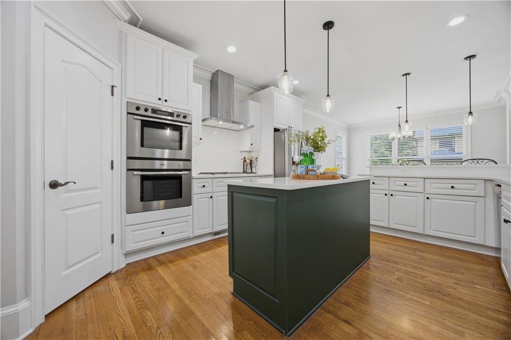 7988 Magnolia Square Atlanta, GA 30350 - Photo 13 of 33 a kitchen with stainless steel appliances a stove a sink and white cabinets
