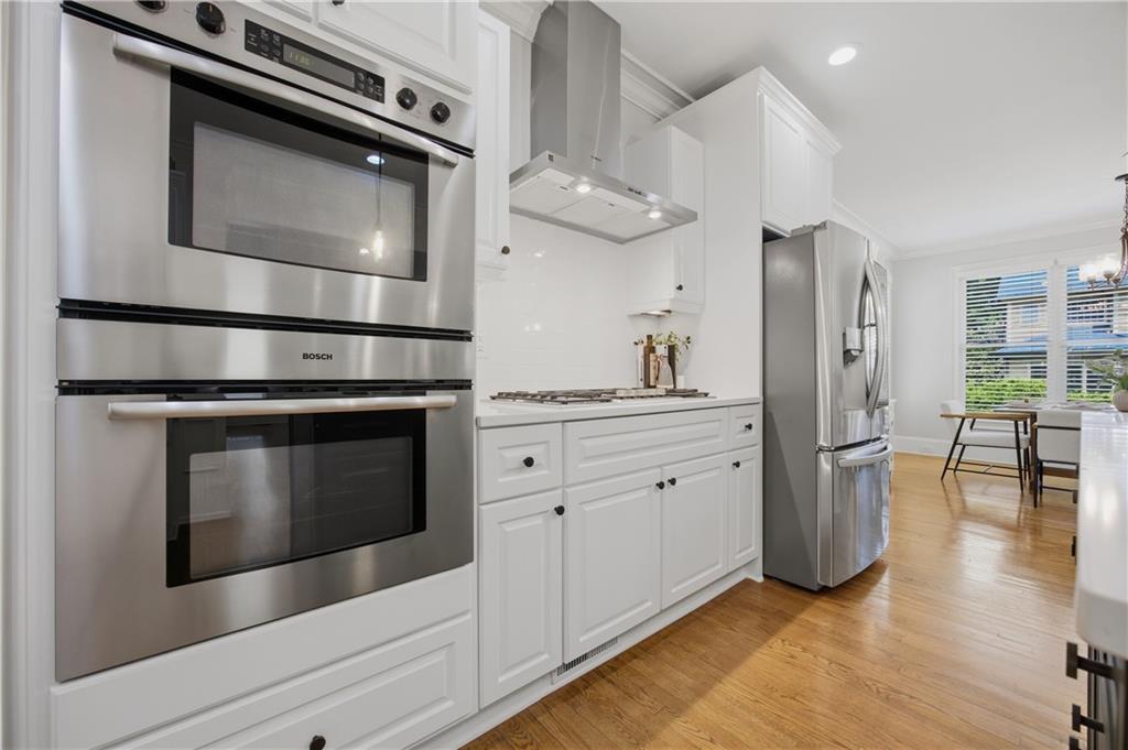 7988 Magnolia Square Atlanta, GA 30350 - Photo 14 of 33 a kitchen with stainless steel appliances a stove a microwave and a refrigerator