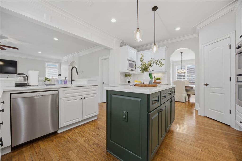 7988 Magnolia Square Atlanta, GA 30350 - Photo 15 of 33 a kitchen with a sink stove and wooden floor