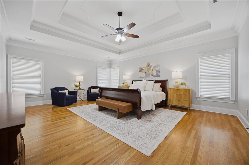 7988 Magnolia Square Atlanta, GA 30350 - Photo 18 of 33 a bedroom with a bed and wooden floor