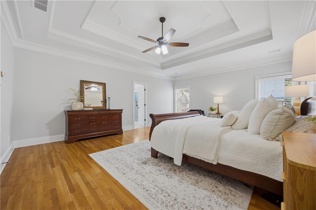 7988 Magnolia Square Atlanta, GA 30350 - Photo 19 of 33 a spacious bedroom with a bed and a chandelier