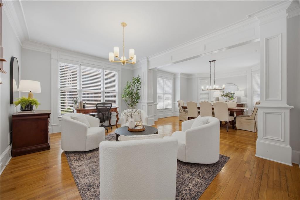 7988 Magnolia Square Atlanta, GA 30350 - Photo 2 of 33 a living room with fireplace furniture and a chandelier