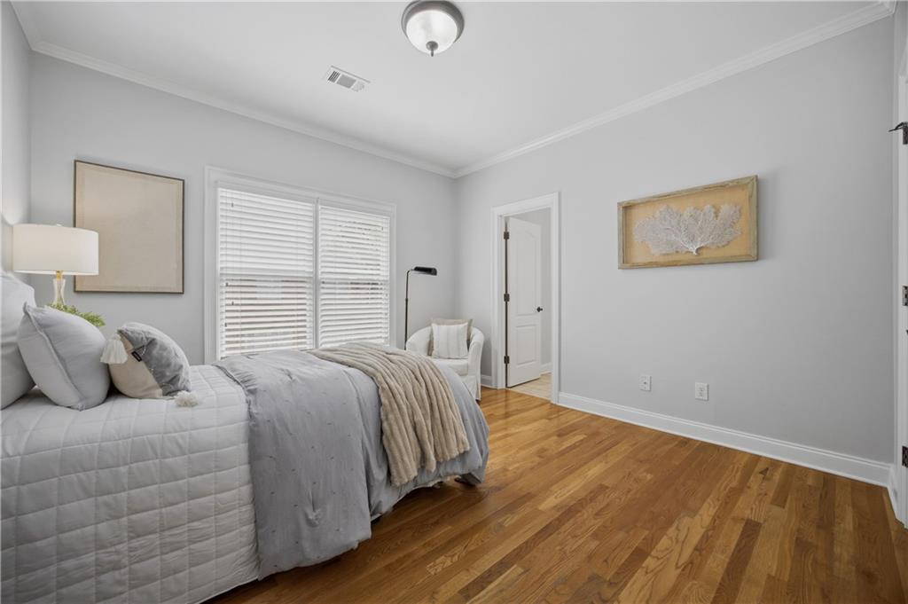 7988 Magnolia Square Atlanta, GA 30350 - Photo 24 of 33 a bedroom with a bed and a night stand
