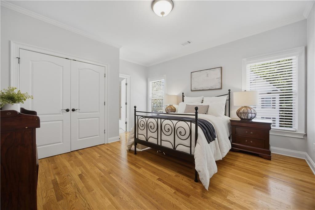 7988 Magnolia Square Atlanta, GA 30350 - Photo 27 of 33 a bedroom with a bed and a potted plant