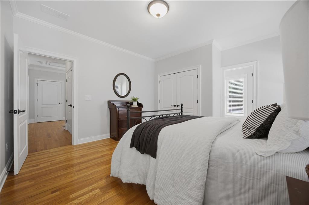 7988 Magnolia Square Atlanta, GA 30350 - Photo 28 of 33 a bedroom with a bed and a chandelier