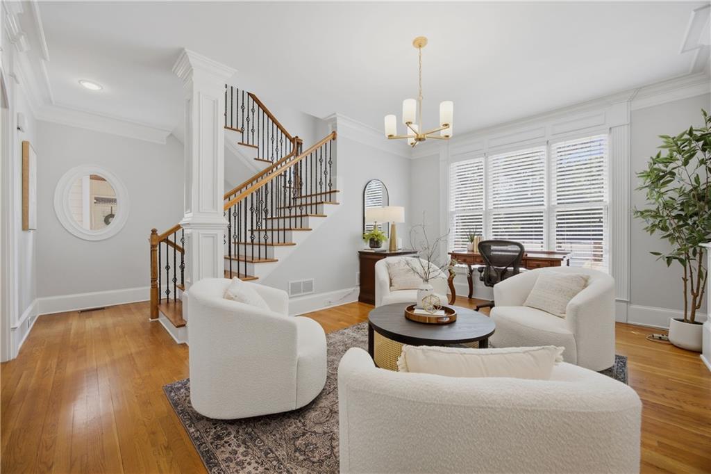 7988 Magnolia Square Atlanta, GA 30350 - Photo 3 of 33 a living room with furniture chandelier and a wooden floor