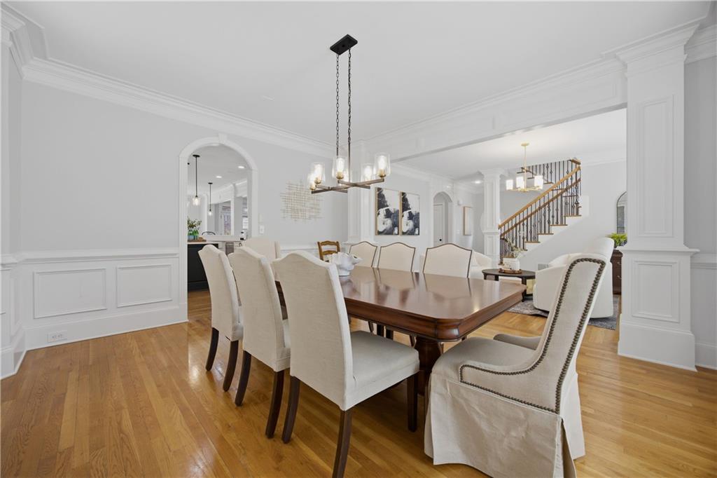 7988 Magnolia Square Atlanta, GA 30350 - Photo 6 of 33 a dining room with furniture a chandelier and wooden floor