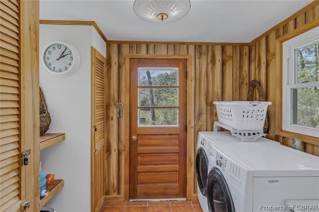 270 Robins Nest Road Lancaster, VA 22503 - Photo 47 of 50 Laundry area with washer and dryer, wooden walls, and light tile floors