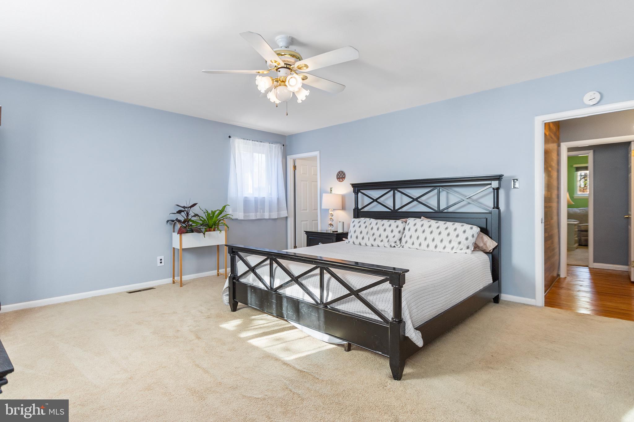 1725 Lawrence Road Havertown, PA 19083 - Photo 12 of 26 a bedroom with a bed chandelier and a window