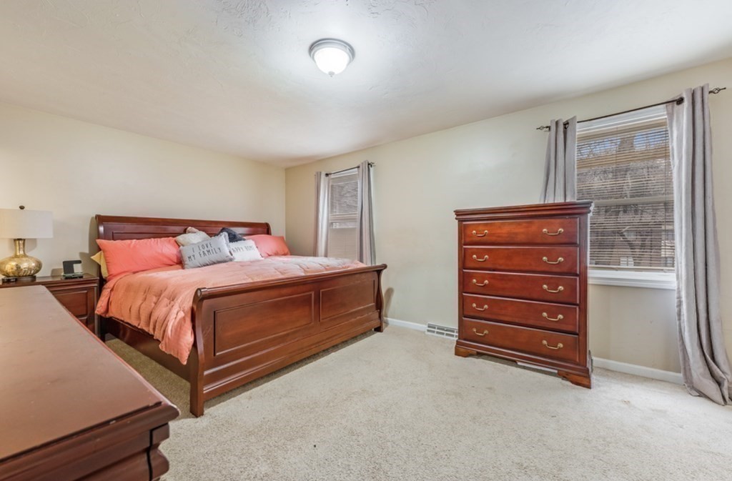 105 Irving Road, Unit 105 Randolph, MA 02368 - Photo 11 of 17 a bedroom with a bed and a dresser