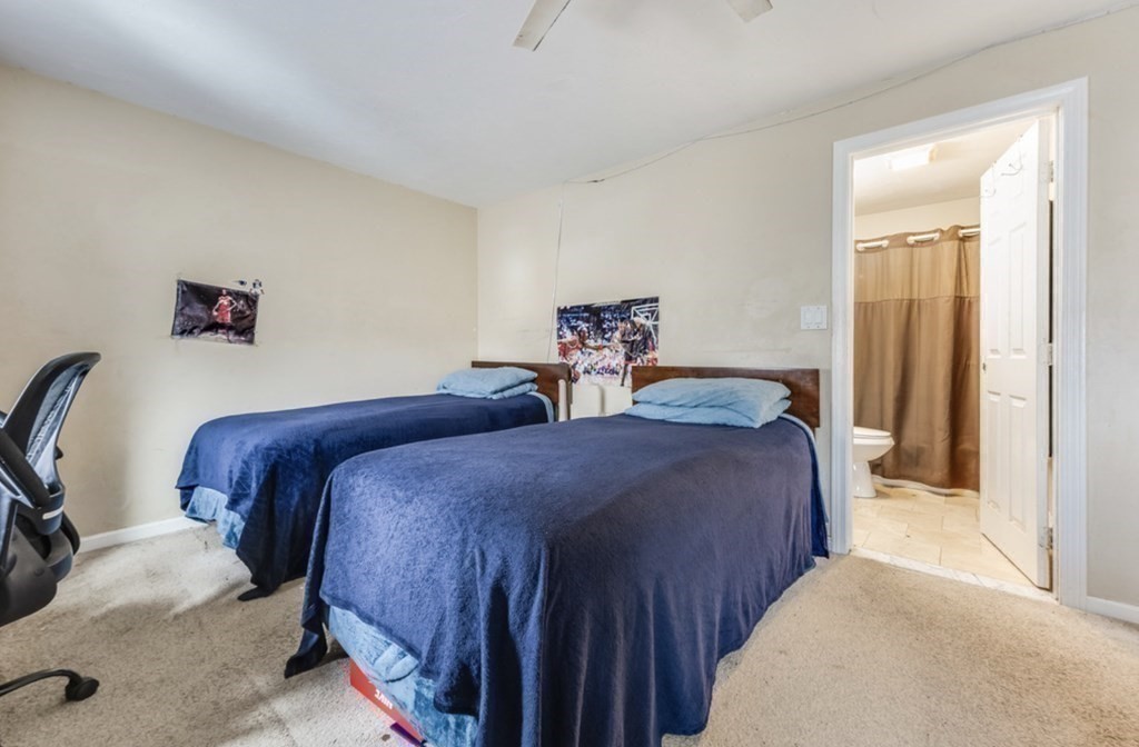 105 Irving Road, Unit 105 Randolph, MA 02368 - Photo 13 of 17 a bedroom with two beds and a dresser with mirror