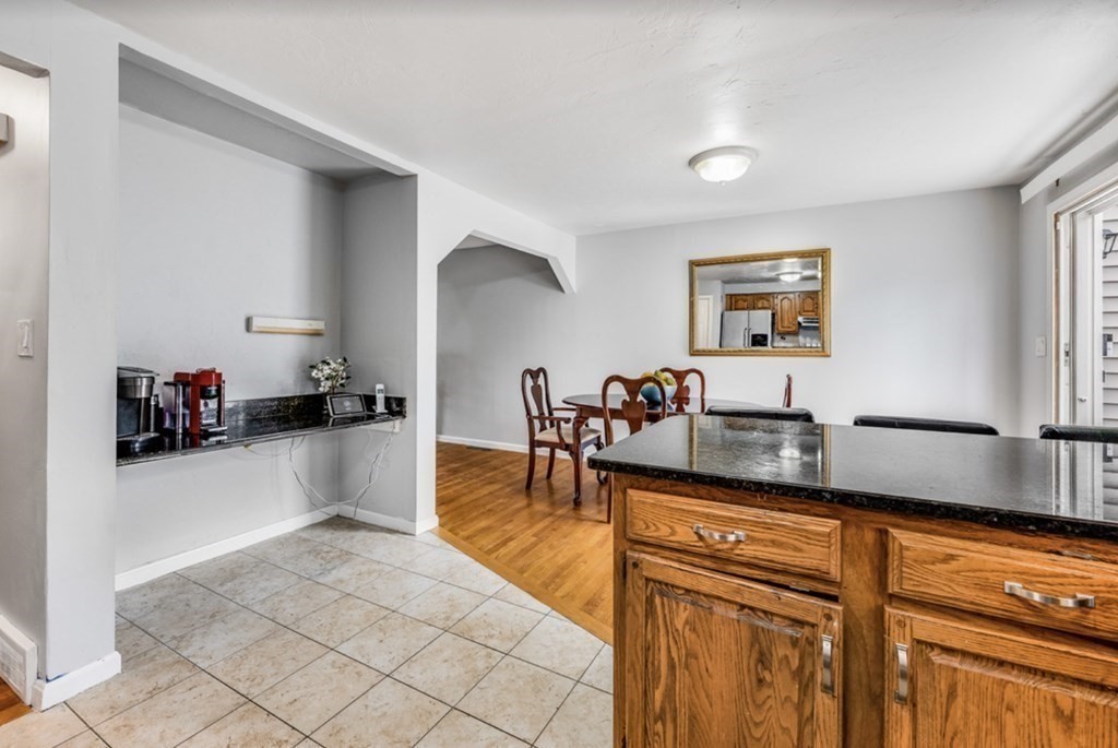 105 Irving Road, Unit 105 Randolph, MA 02368 - Photo 4 of 17 a kitchen with stainless steel appliances granite countertop a sink and cabinets