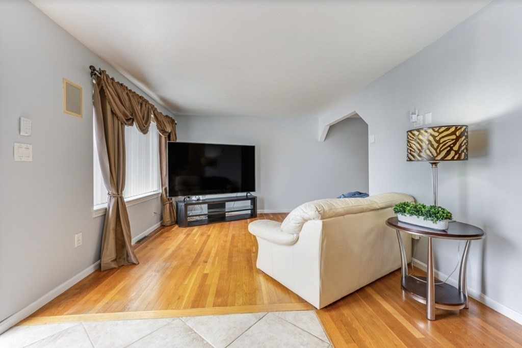 105 Irving Road, Unit 105 Randolph, MA 02368 - Photo 9 of 17 a living room with furniture and a flat screen tv